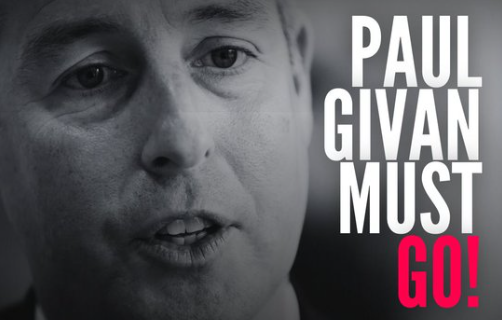 Black and White Image of Paul Givan's face with slogan 'Paul Givan Must Go!'