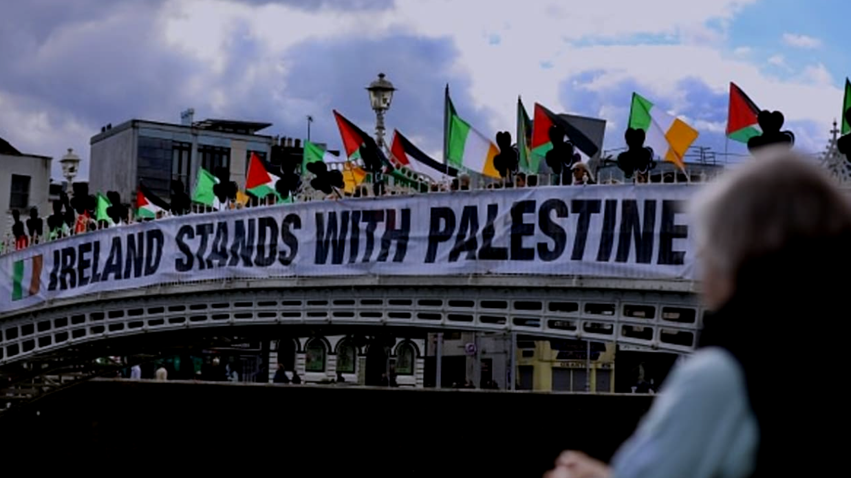Hapenny Bridge with a large banner across it saying Ireland Stands With Palestine.