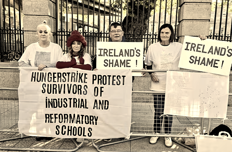 Hunger Strikers at the Dail with signs saying Ireland's Shame and Hungerstrike Protest Survivors of Industrial and Reformatory Schools